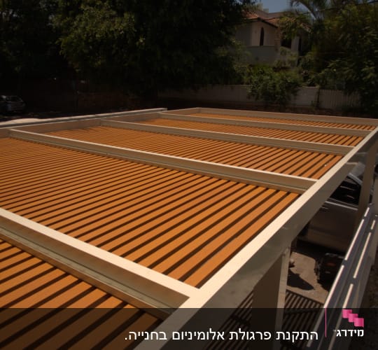 גג עץ עם קורות לבנות בחצר בית